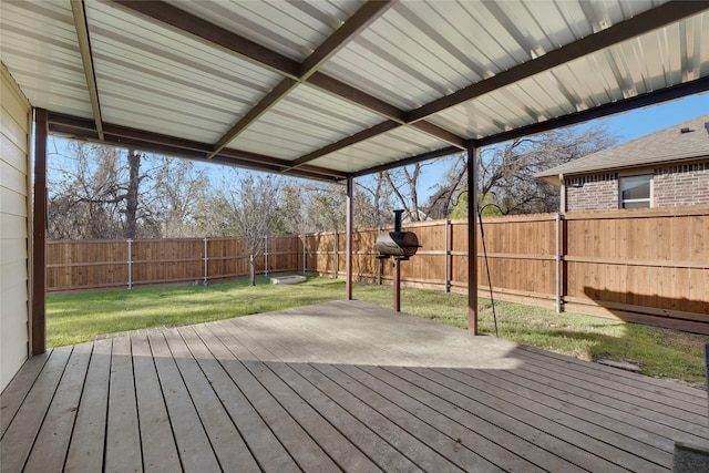 wooden deck featuring a lawn