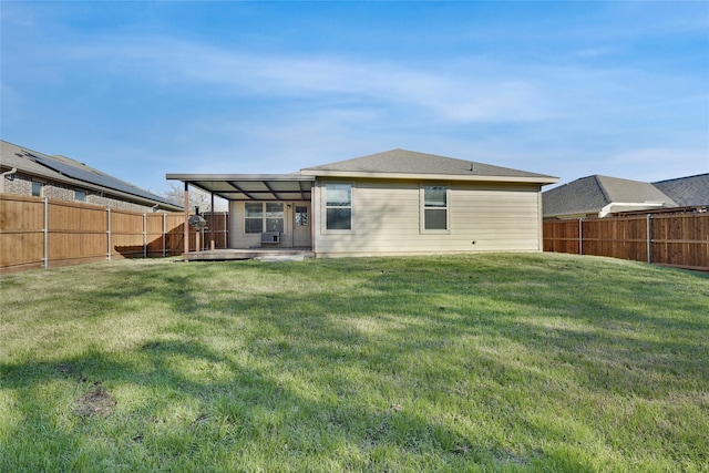 back of house featuring a lawn