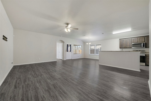 unfurnished living room featuring ceiling fan with notable chandelier and dark hardwood / wood-style flooring