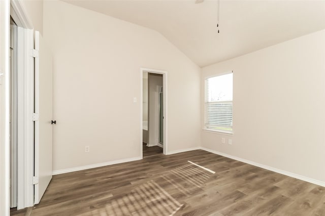 unfurnished bedroom with lofted ceiling and dark hardwood / wood-style flooring