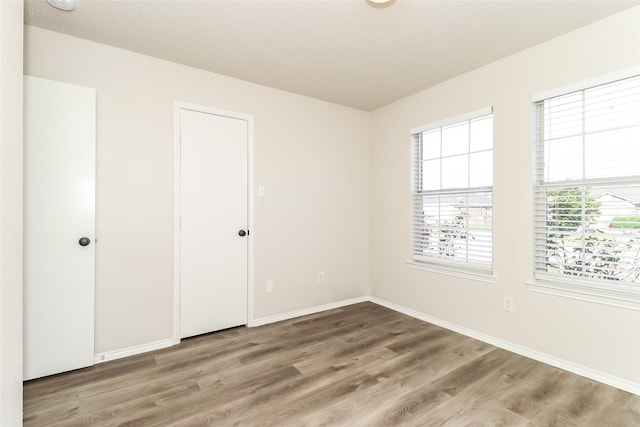 unfurnished bedroom with hardwood / wood-style floors