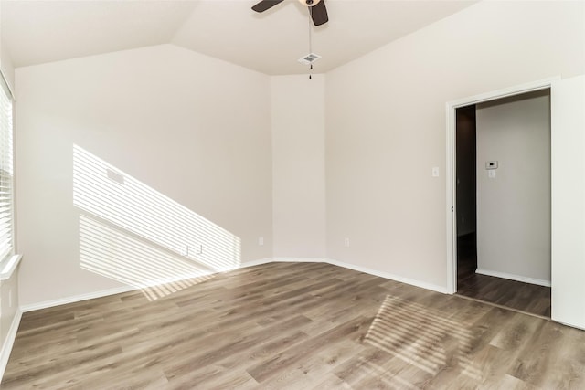 unfurnished room with ceiling fan, wood-type flooring, and vaulted ceiling