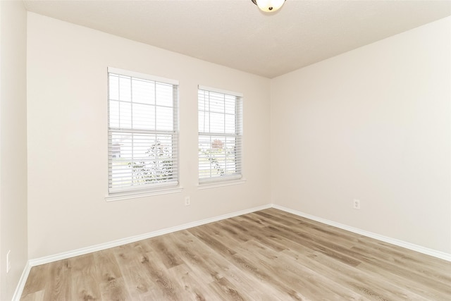 unfurnished room with light wood-type flooring