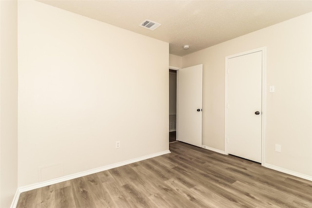 unfurnished room featuring wood-type flooring