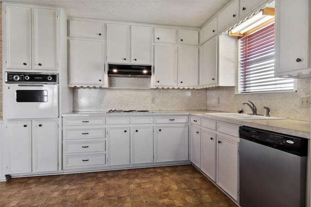 kitchen featuring white cabinetry, sink, stainless steel appliances, and a textured ceiling