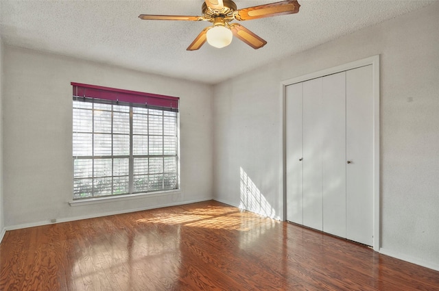 unfurnished bedroom with multiple windows, a textured ceiling, and ceiling fan