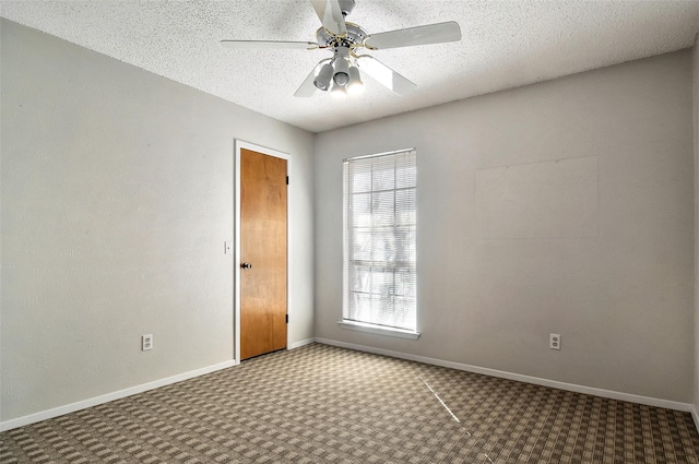 carpeted empty room with ceiling fan and a textured ceiling