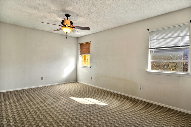 carpeted spare room with ceiling fan and a textured ceiling