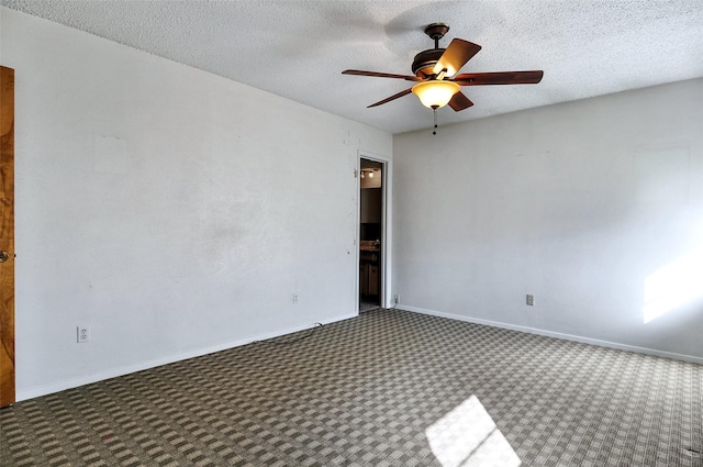 carpeted empty room featuring ceiling fan and a textured ceiling