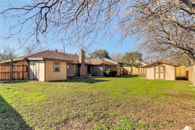 back of house featuring a yard and a storage shed