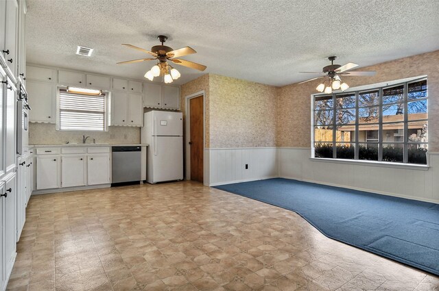 kitchen featuring white cabinetry, dishwasher, white fridge, and sink