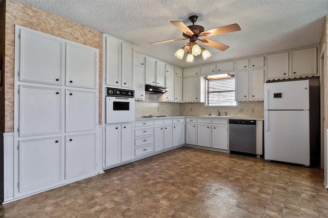 kitchen featuring backsplash, white appliances, ceiling fan, sink, and white cabinetry