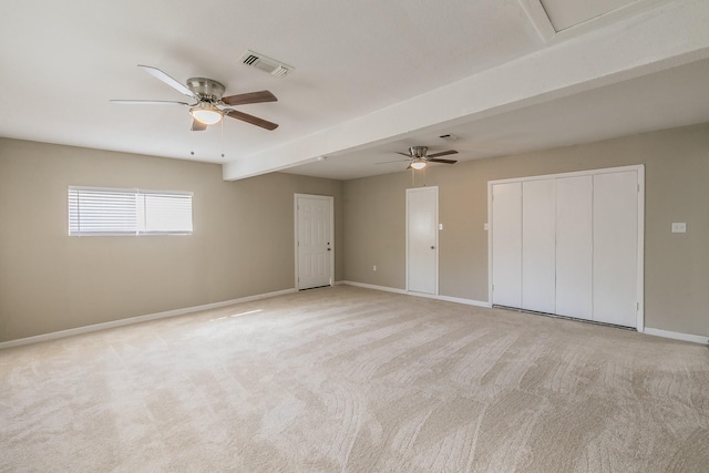 spare room with ceiling fan and light carpet