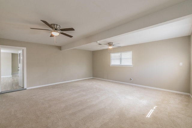 empty room featuring ceiling fan and light colored carpet