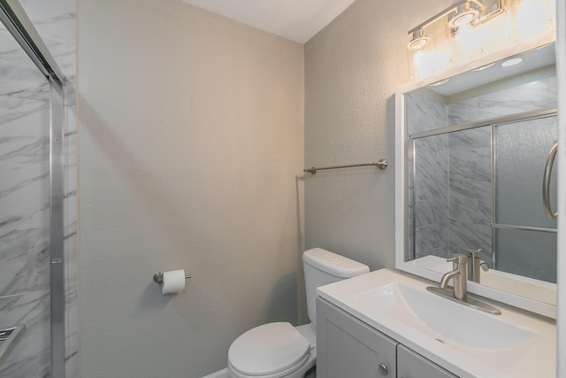 bathroom with vanity, toilet, and an enclosed shower