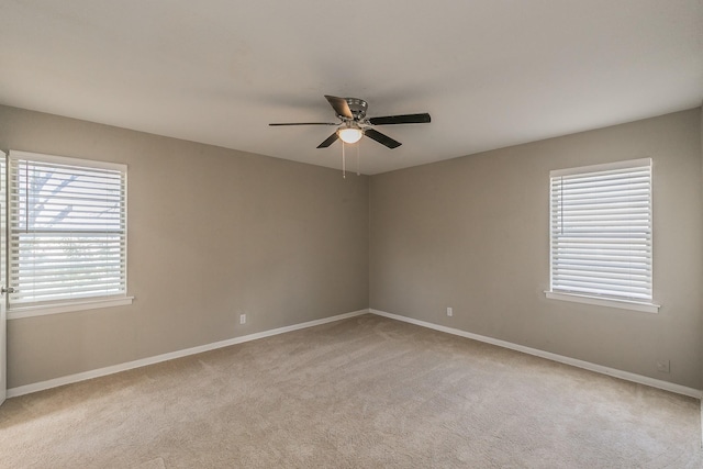 empty room with light colored carpet and ceiling fan