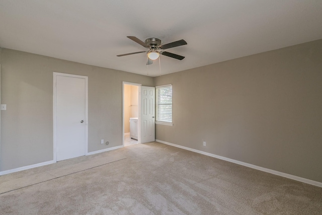 unfurnished bedroom featuring ceiling fan, light colored carpet, and ensuite bathroom