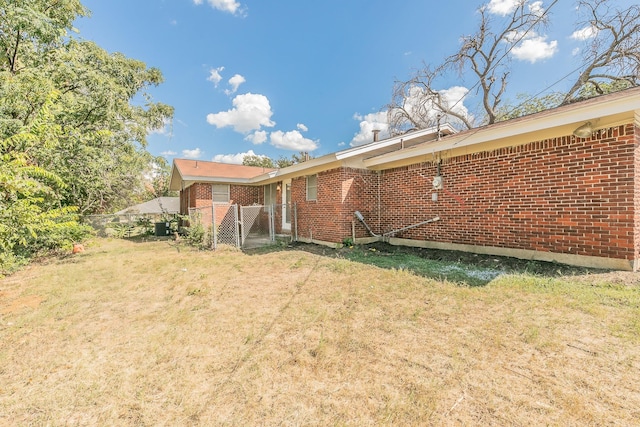 rear view of property with a yard