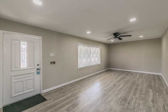 foyer entrance with ceiling fan, a healthy amount of sunlight, and light hardwood / wood-style floors