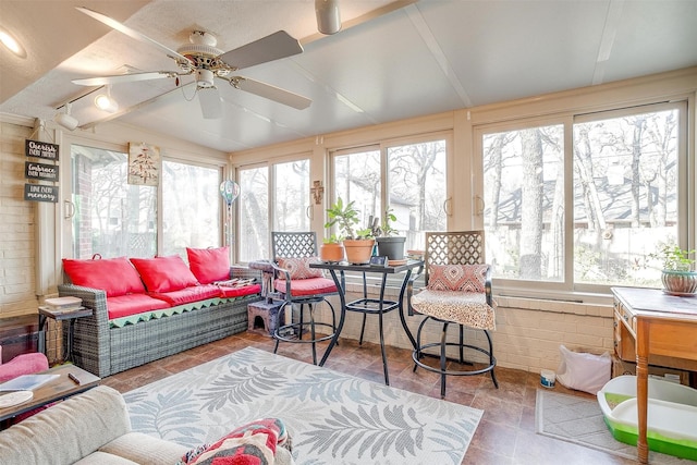 sunroom featuring plenty of natural light and ceiling fan