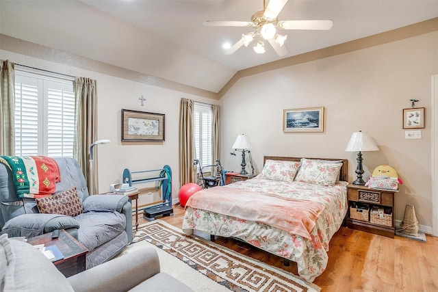 bedroom featuring ceiling fan, lofted ceiling, and light hardwood / wood-style flooring