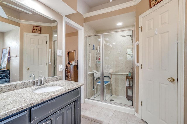 bathroom featuring tile patterned flooring, vanity, an enclosed shower, and ornamental molding