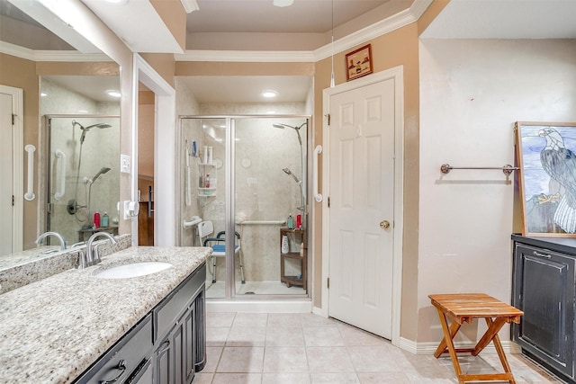 bathroom featuring tile patterned flooring, vanity, an enclosed shower, and crown molding