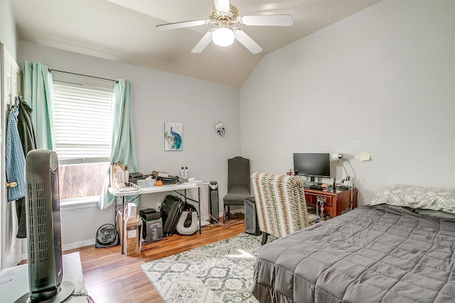 bedroom featuring light wood-type flooring, ceiling fan, and lofted ceiling