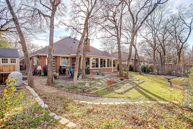 rear view of house featuring a yard and a patio