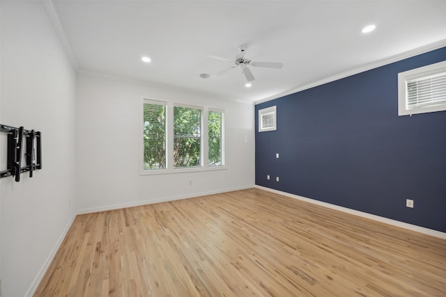 spare room featuring light hardwood / wood-style flooring, ceiling fan, and ornamental molding