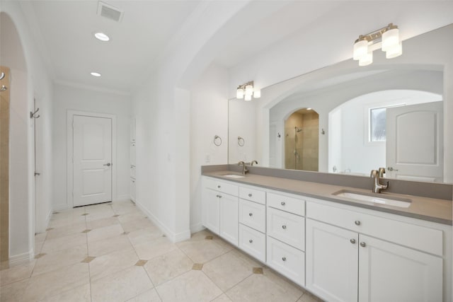 bathroom with crown molding, tile patterned flooring, and vanity