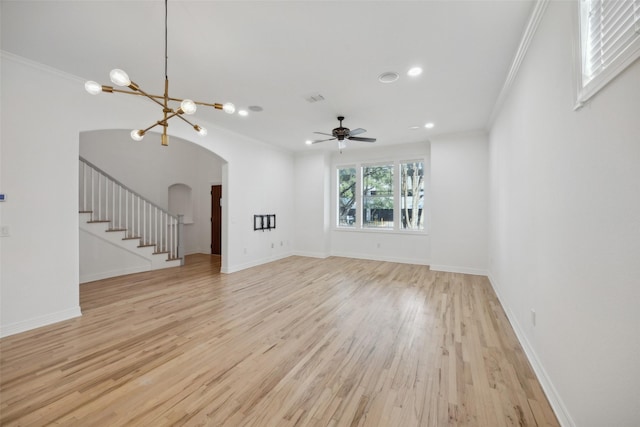 unfurnished living room featuring ceiling fan with notable chandelier, ornamental molding, and light hardwood / wood-style flooring