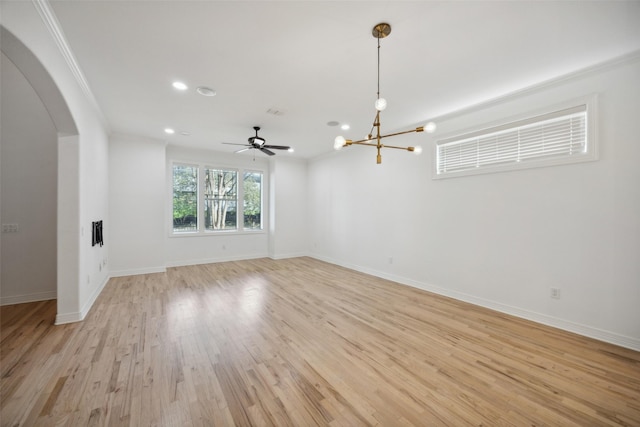 empty room with crown molding, light hardwood / wood-style flooring, and ceiling fan with notable chandelier