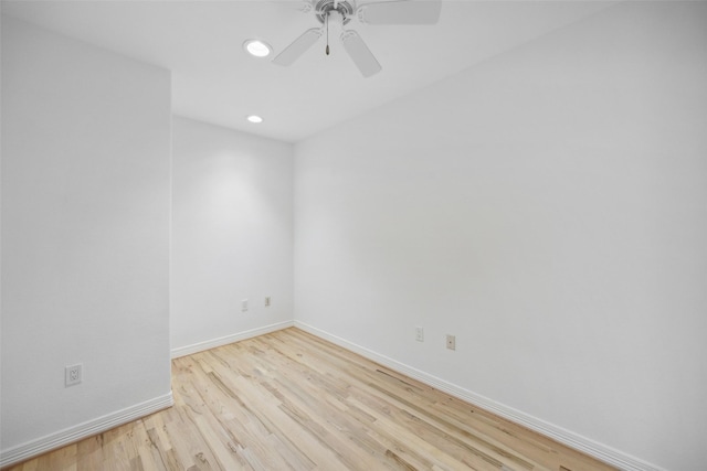 empty room with ceiling fan and light hardwood / wood-style flooring