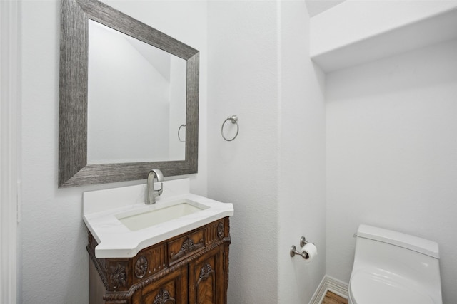 bathroom featuring vanity and toilet