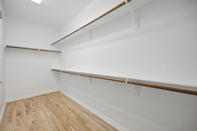 spacious closet featuring light hardwood / wood-style floors