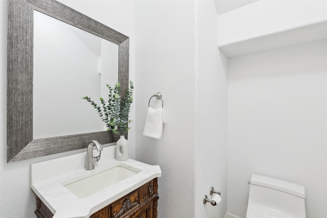 bathroom with vanity and toilet