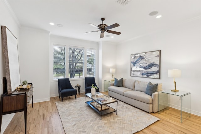 living room featuring light wood-type flooring, ceiling fan, and crown molding