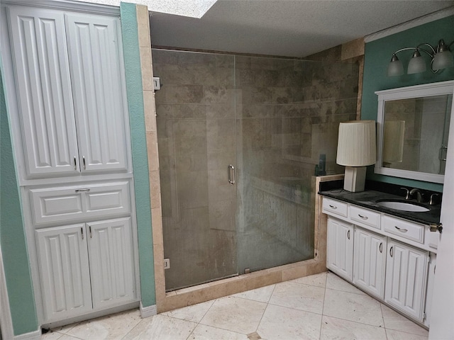 bathroom with tile patterned floors, a shower with door, and vanity