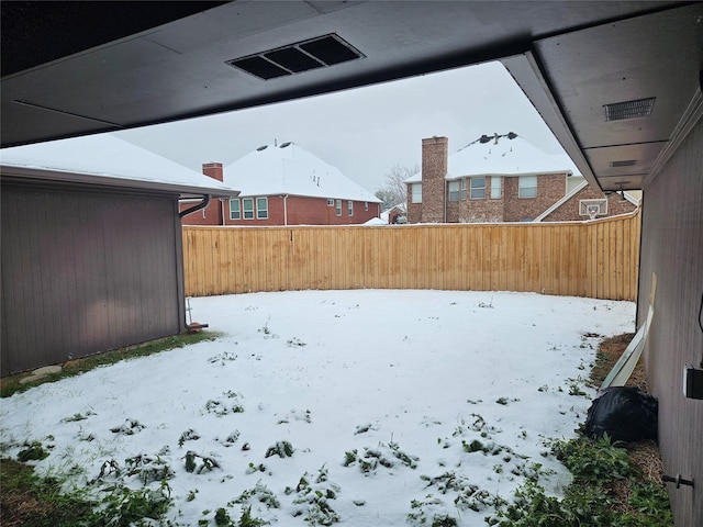 view of yard layered in snow