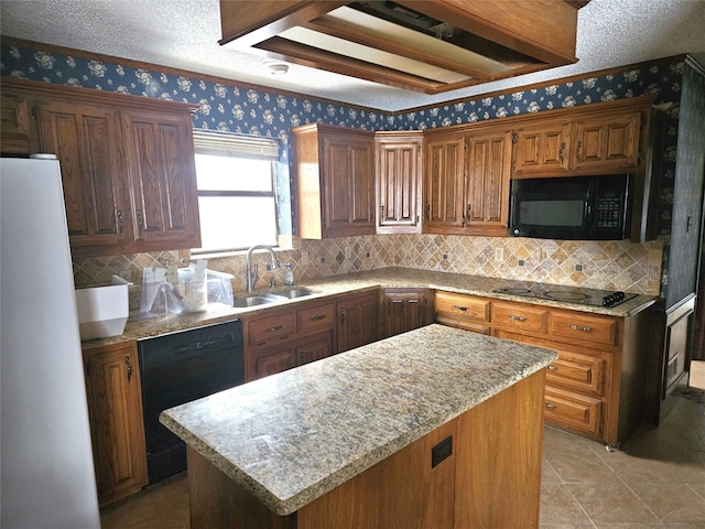 kitchen with a textured ceiling, sink, black appliances, light tile patterned floors, and a kitchen island