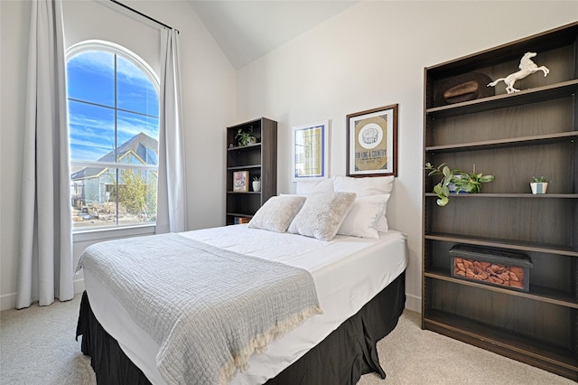 carpeted bedroom with vaulted ceiling