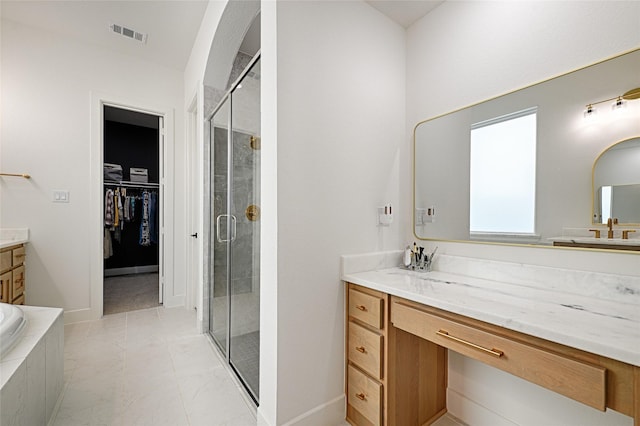 bathroom with independent shower and bath and vanity