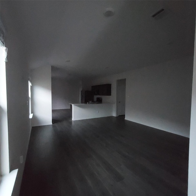 unfurnished living room featuring dark wood-type flooring