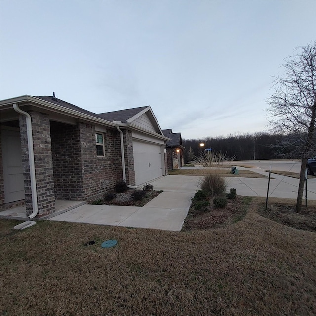 view of property exterior featuring a yard and a garage