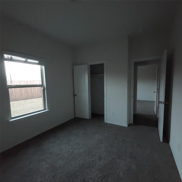 unfurnished bedroom featuring dark colored carpet