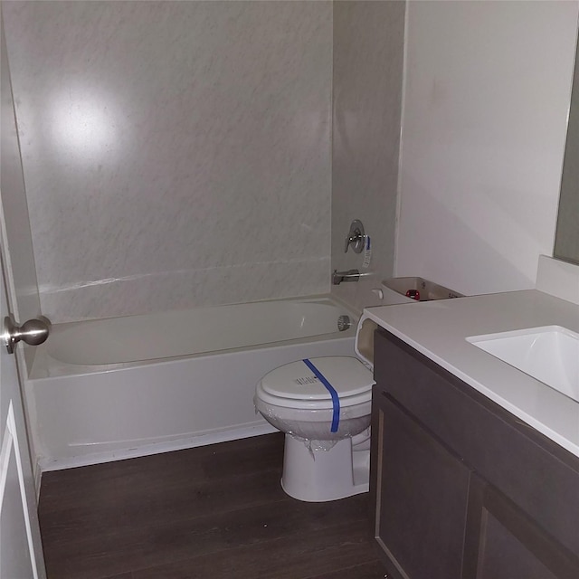 full bathroom featuring bathtub / shower combination, wood-type flooring, toilet, and vanity