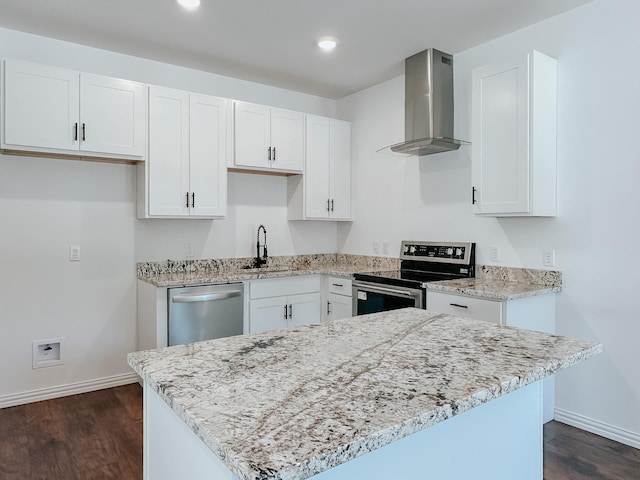 kitchen with white cabinets, sink, wall chimney range hood, and stainless steel appliances