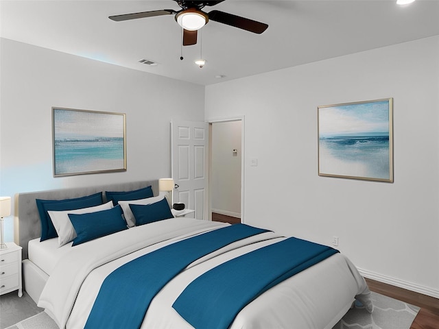 bedroom with ceiling fan and hardwood / wood-style floors