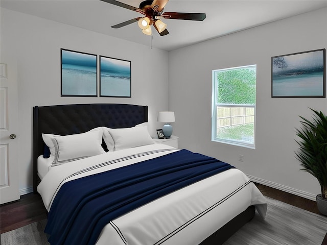 bedroom featuring ceiling fan and dark hardwood / wood-style flooring